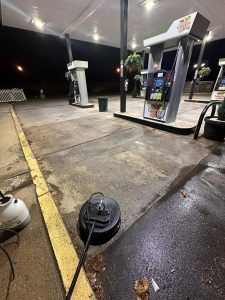 Gas station washing around pumps